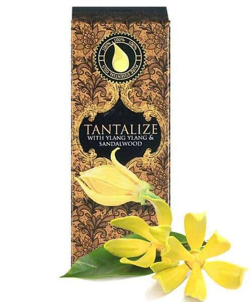essential oil for love - wildfire tantalize 10ml essenial oil box with ylang ylang flower in the foreground
